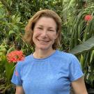 A woman surrounded by plants smiling